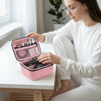 Woman arranging camera gear inside the pink organizer