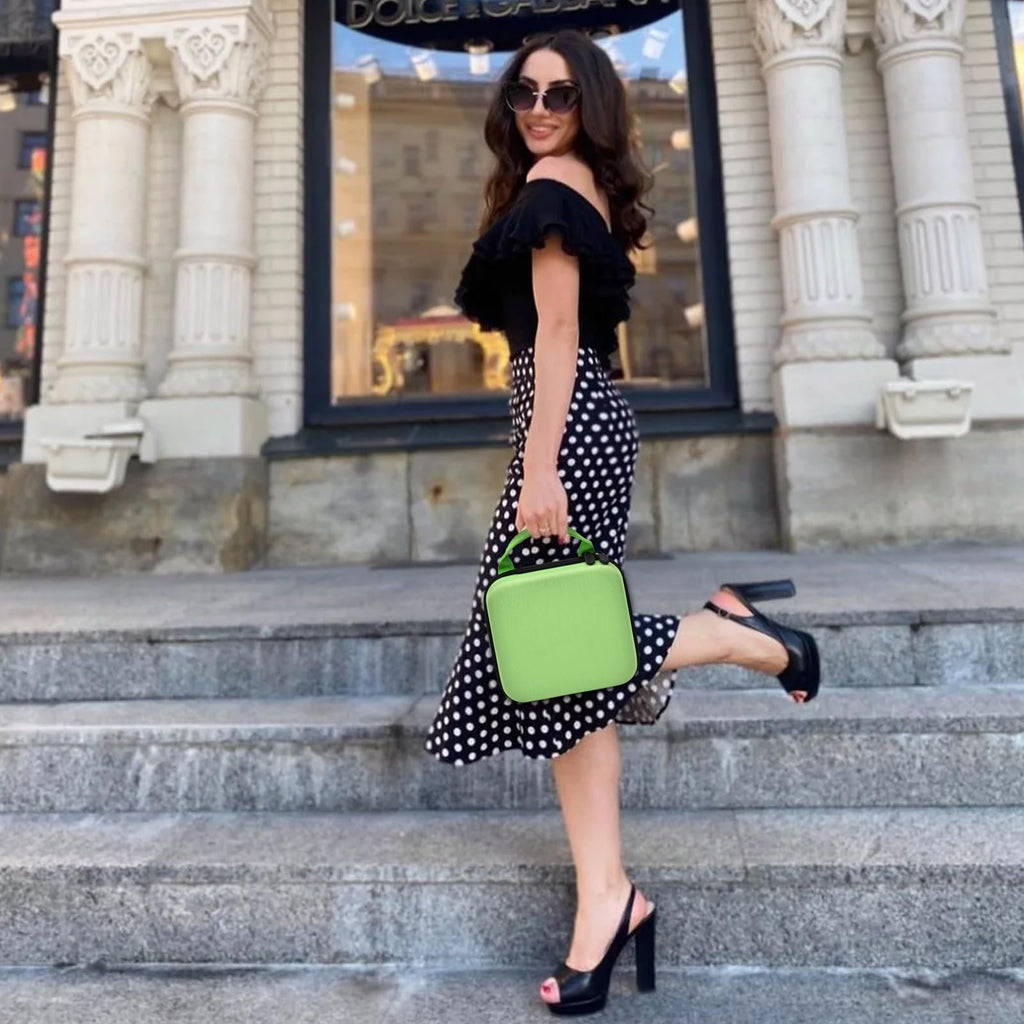 Person carrying the bright green NIIMBOT label maker case by its top handle
