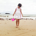 Magenta kids instant print camera case carried by a child outdoors