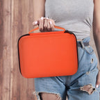 Person carrying the orange label maker case by its handle