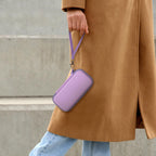 Person carrying the purple power bank case by its wrist strap