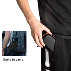 Person carrying the black and orange SSD case by its carabiner