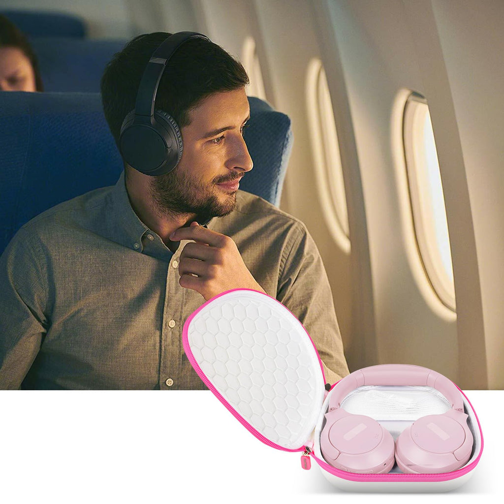 Traveler using headphones beside the open white with pink trim carrying case on an airplane