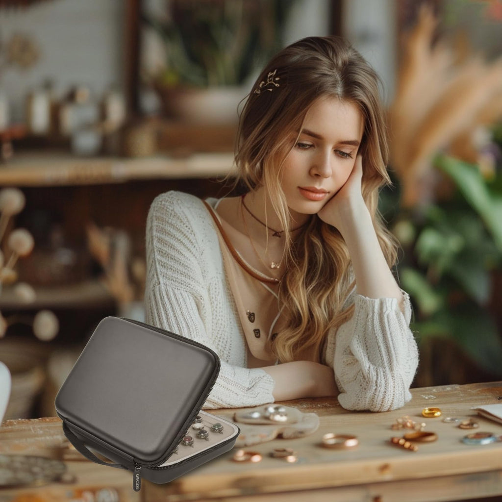 Woman using the gray ring organizer on a jewelry worktable