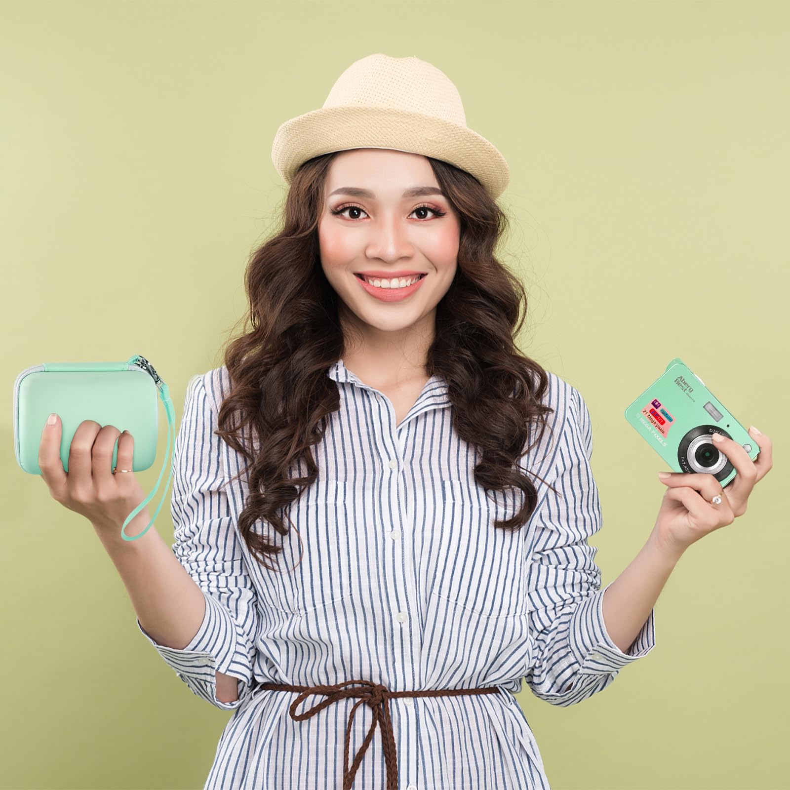 Woman holding the mint green camera case beside a compact digital camera