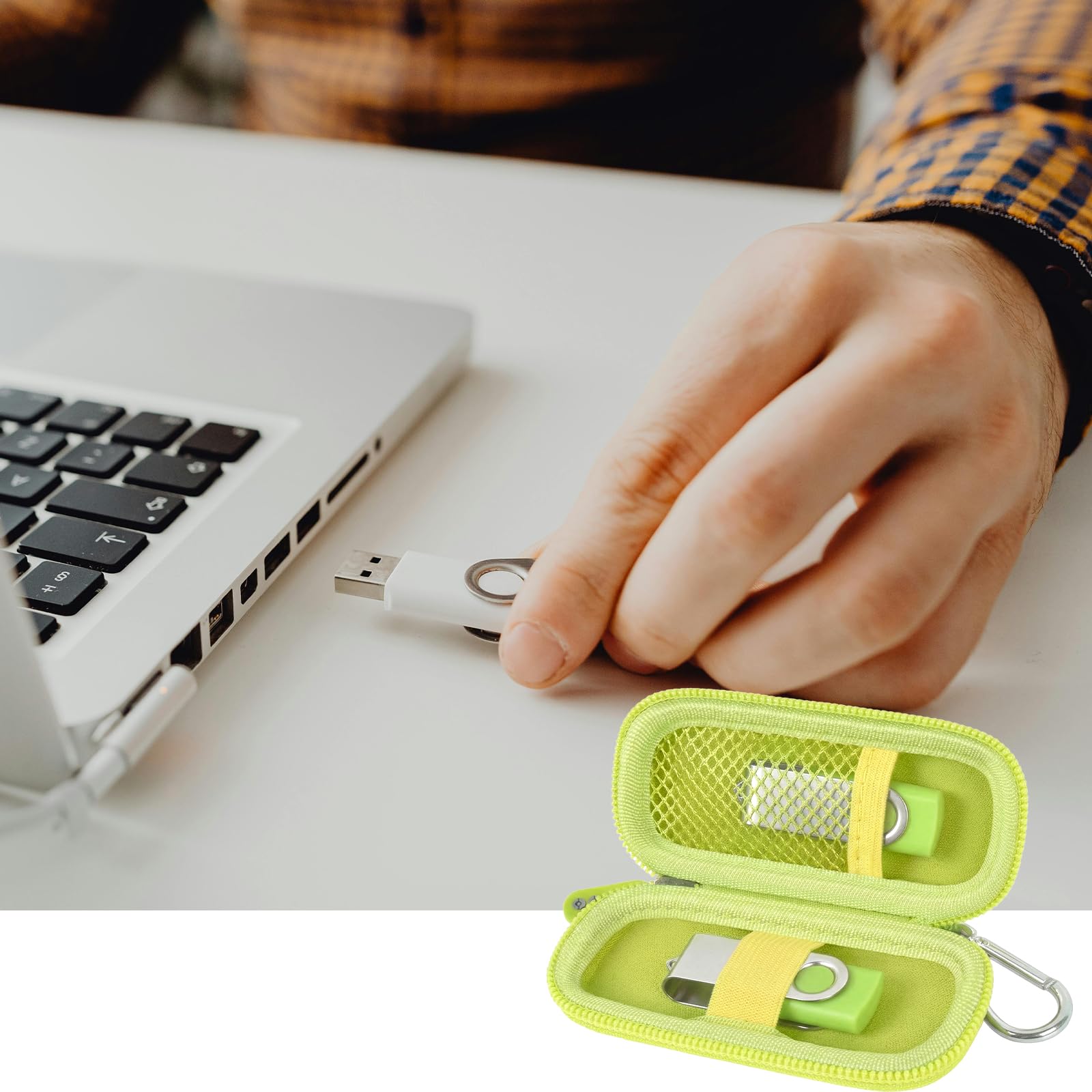 Neon green USB flash drive and SD card storage case open beside a laptop during use