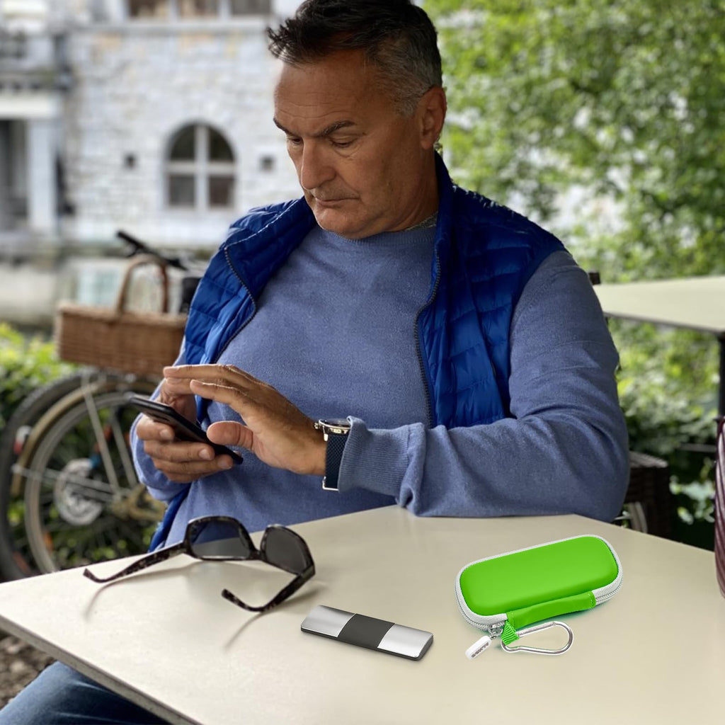 Man using a KardiaMobile device beside the open green travel case