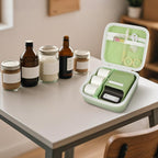 Open light green NIIMBOT label maker organizer beside bottles and jars