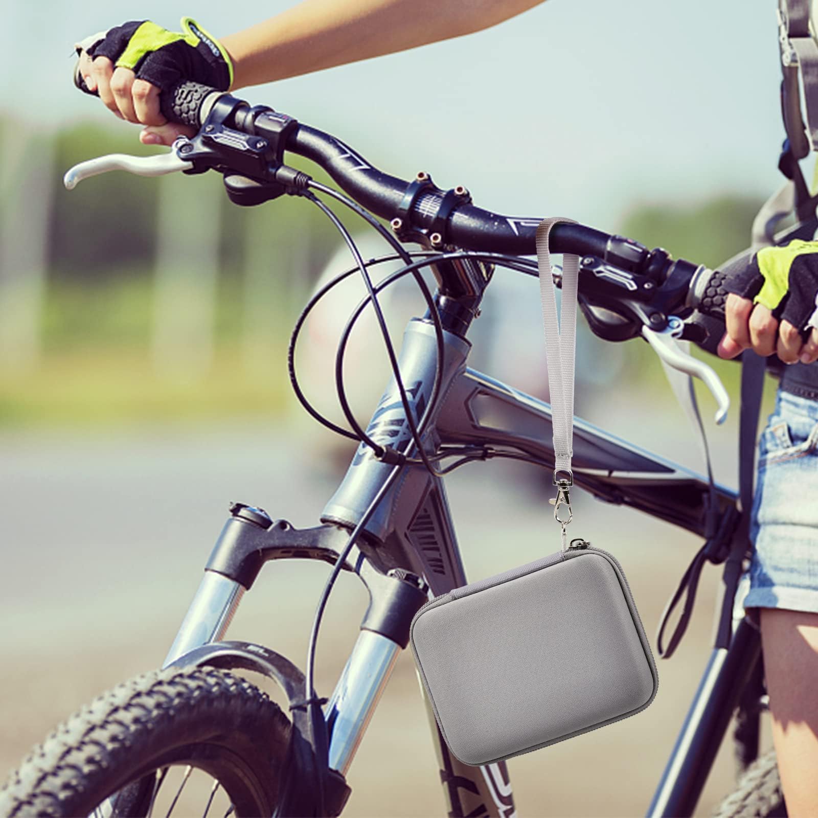 Gray camera case attached to a bicycle handlebar