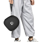Person carrying the black headphone case by its wrist strap