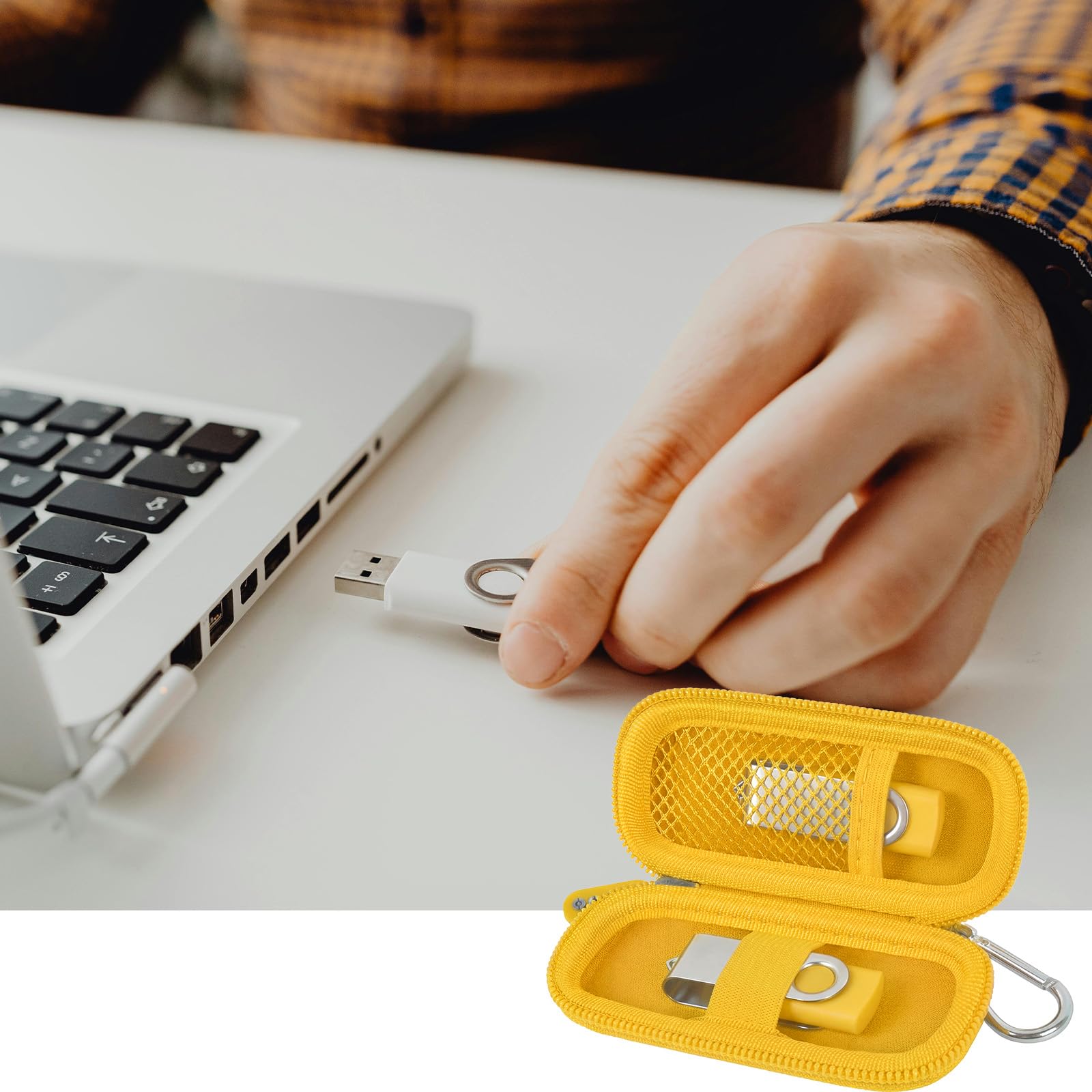 Yellow USB flash drive and SD card storage case open beside a laptop during use