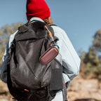 Rose gold KardiaMobile case clipped to a hiking backpack