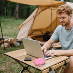 Open pink SSD organizer beside a Crucial portable drive connected to a laptop