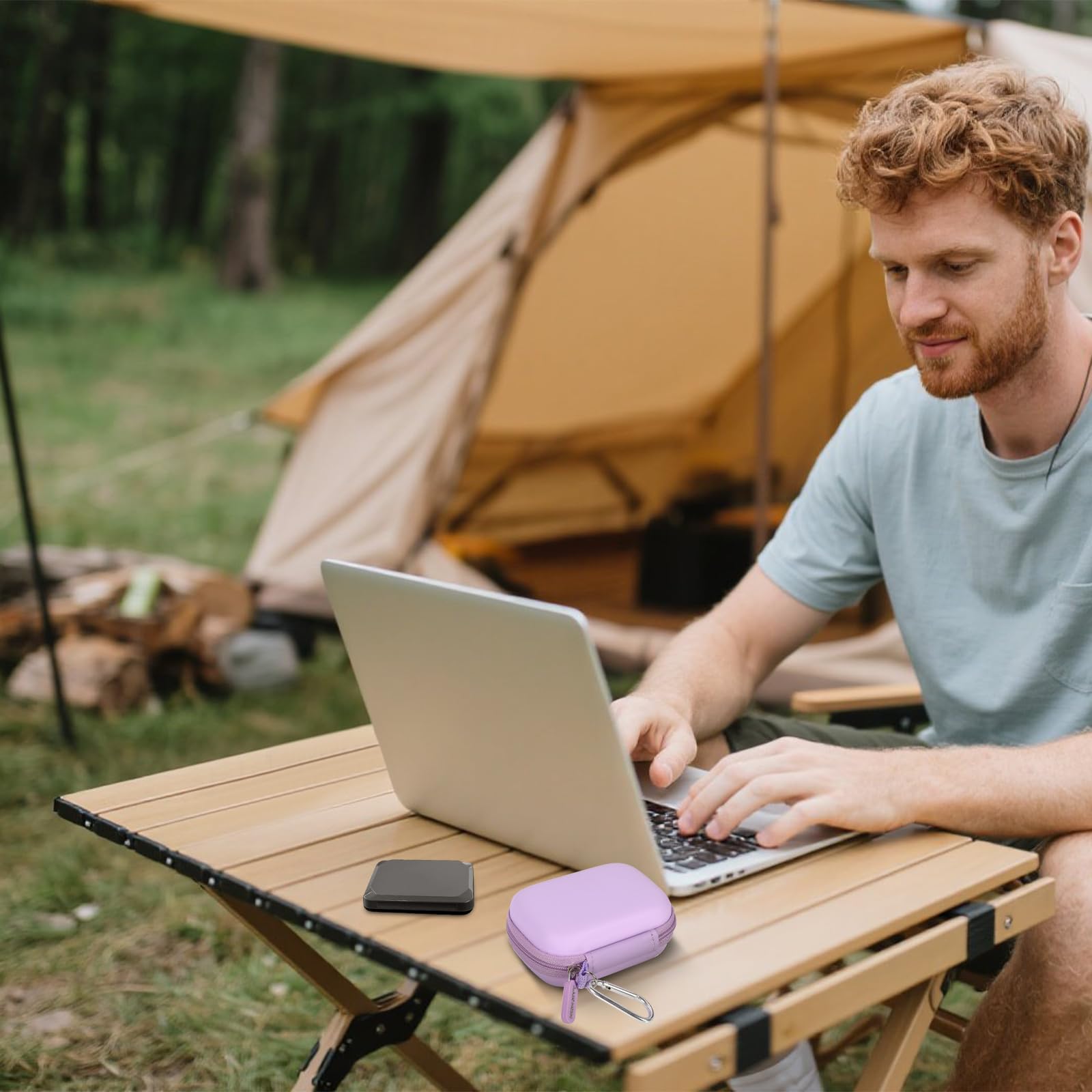 Lavender SSD case beside a portable drive during outdoor laptop use