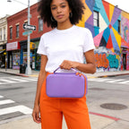 Woman carrying the purple dual microphone case by its top handle