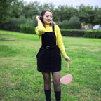 Woman carrying the pink headphone case by its wrist strap