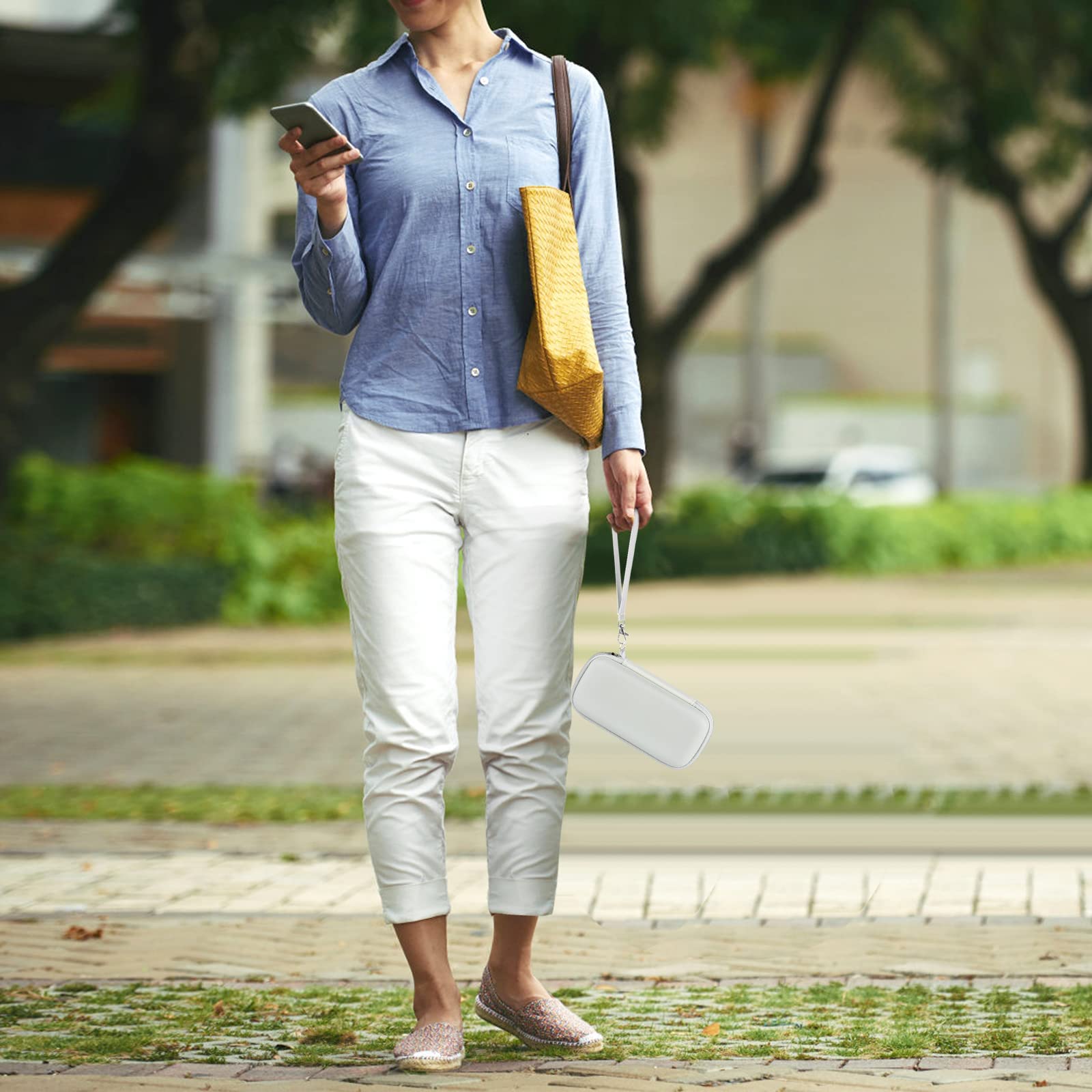 Person carrying the white power bank case by its wrist strap