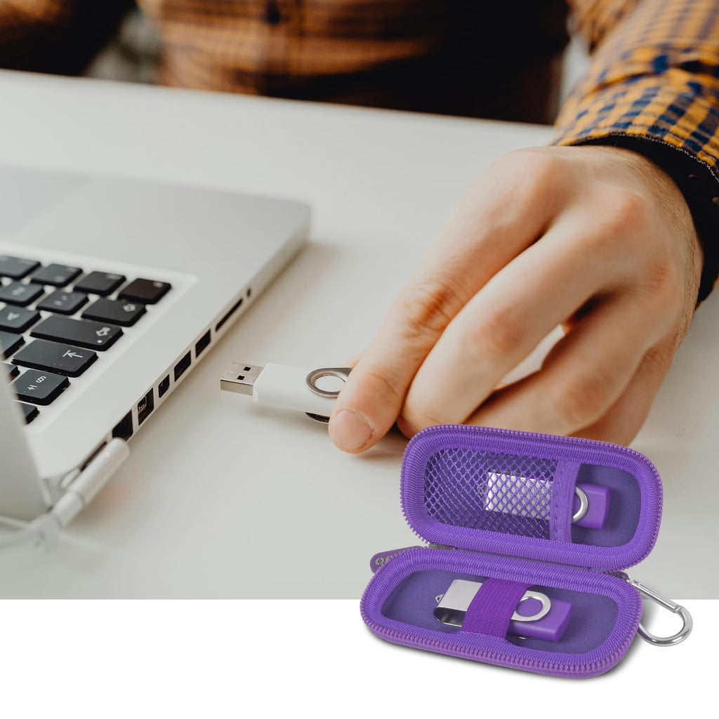 Purple USB flash drive and SD card storage case open beside a laptop during use