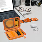 Open orange case organizing a foldable magnetic charger, cable, and adapter on a desk