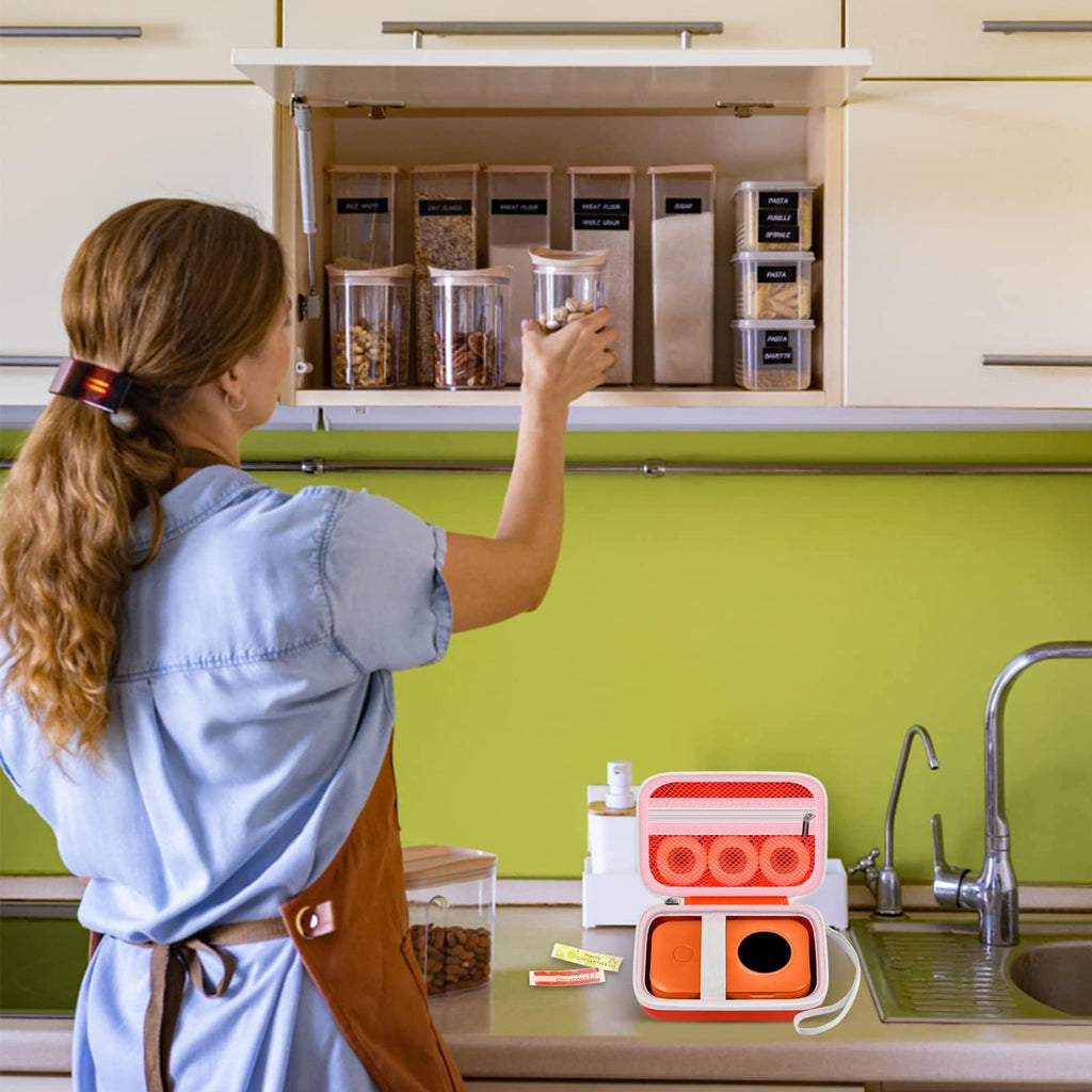 Orange label maker case beside a mini printer in a kitchen organization scene