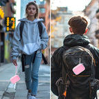 Pink and mint green JBL Go speaker case carried by hand and attached to a backpack