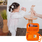 Orange protective digital camera case shown beside a child using a compact camera
