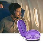 Traveler using headphones beside the open purple carrying case on an airplane
