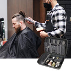 Barber using clippers beside an open gray grooming organizer case