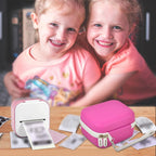 Children using a mini label printer beside the magenta carrying case