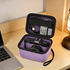 Open purple camera case organizing a camera and accessories beside a laptop