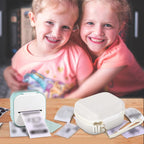 Children using a mini label printer beside the white carrying case