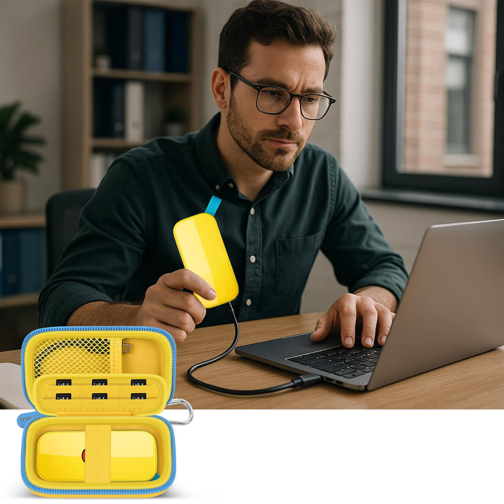 Man using a SanDisk portable SSD beside the open yellow organizer and laptop