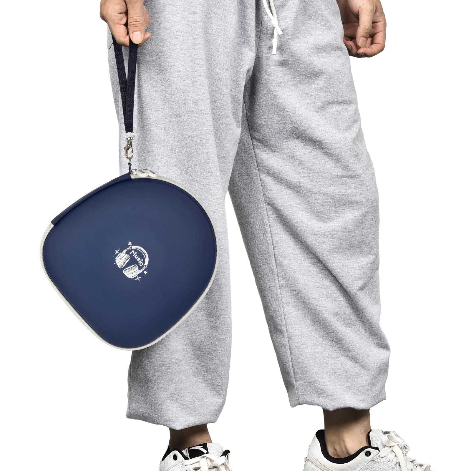 Person carrying the navy blue headphone case by its wrist strap