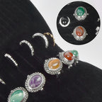 Rings and earrings displayed in the black organizer's parallel jewelry slots