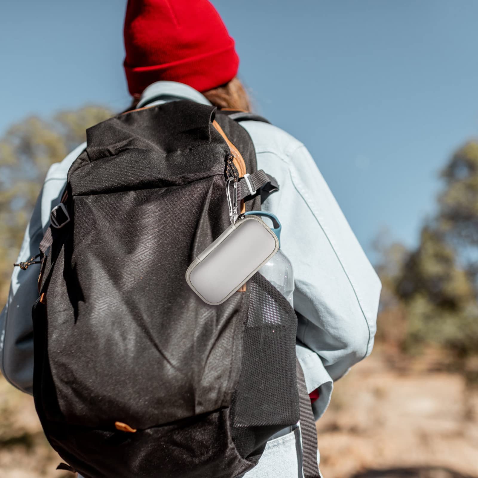 White KardiaMobile case clipped to a hiking backpack