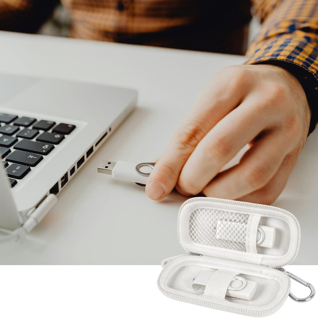 White USB flash drive and SD card storage case open beside a laptop during use