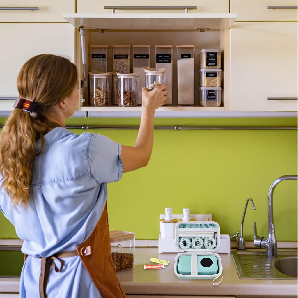 Mint green label maker case beside a mini printer in a kitchen organization scene