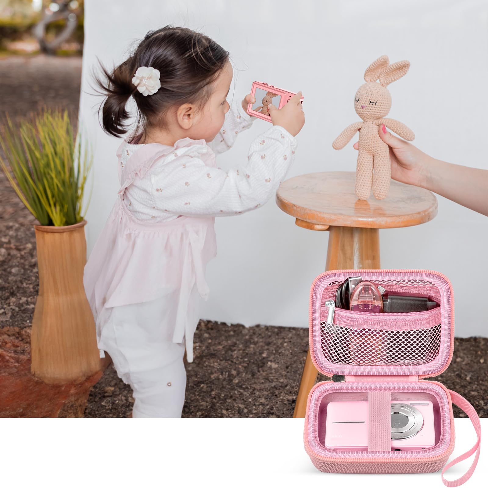 Pink protective digital camera case shown beside a child using a compact camera
