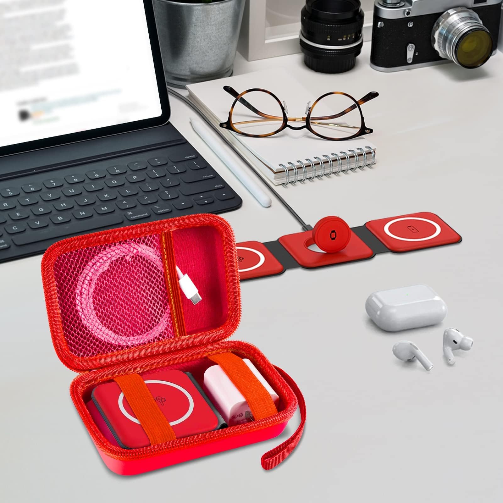 Open red case organizing a foldable magnetic charger, cable, and adapter on a desk