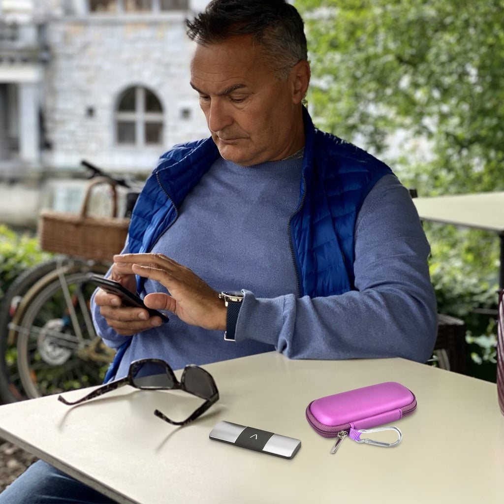 Man using a KardiaMobile device beside the open purple travel case