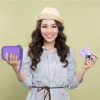 Woman holding the purple camera case beside a compact digital camera