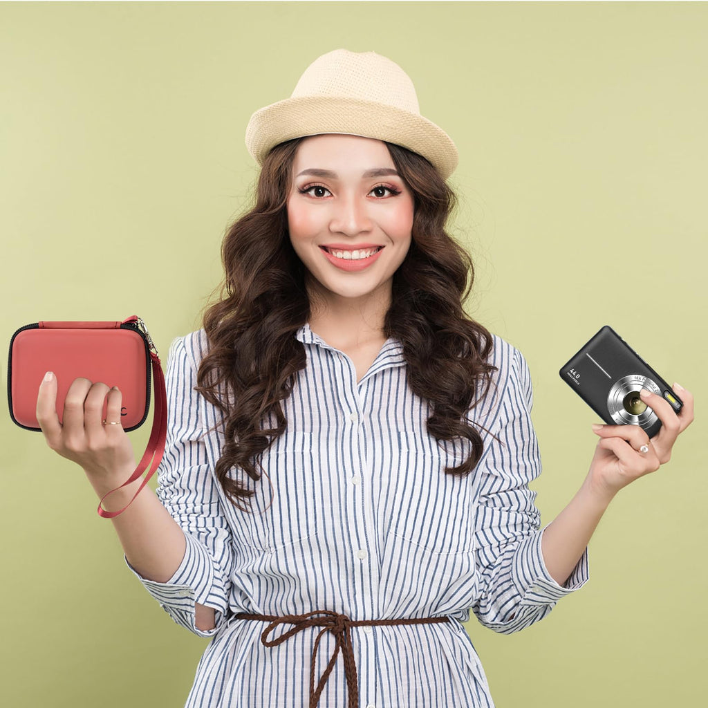 Woman holding the coral and brown camera case beside a compact digital camera