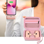 Open light pink case organizing a mini power bank and cable beside a charging phone