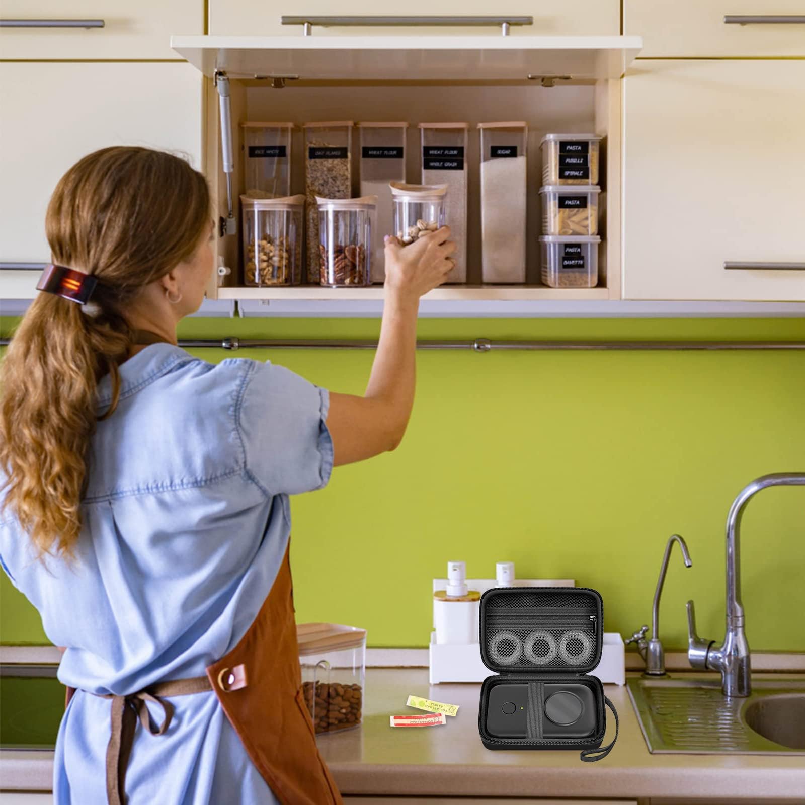 Black label maker case beside a mini printer in a kitchen organization scene