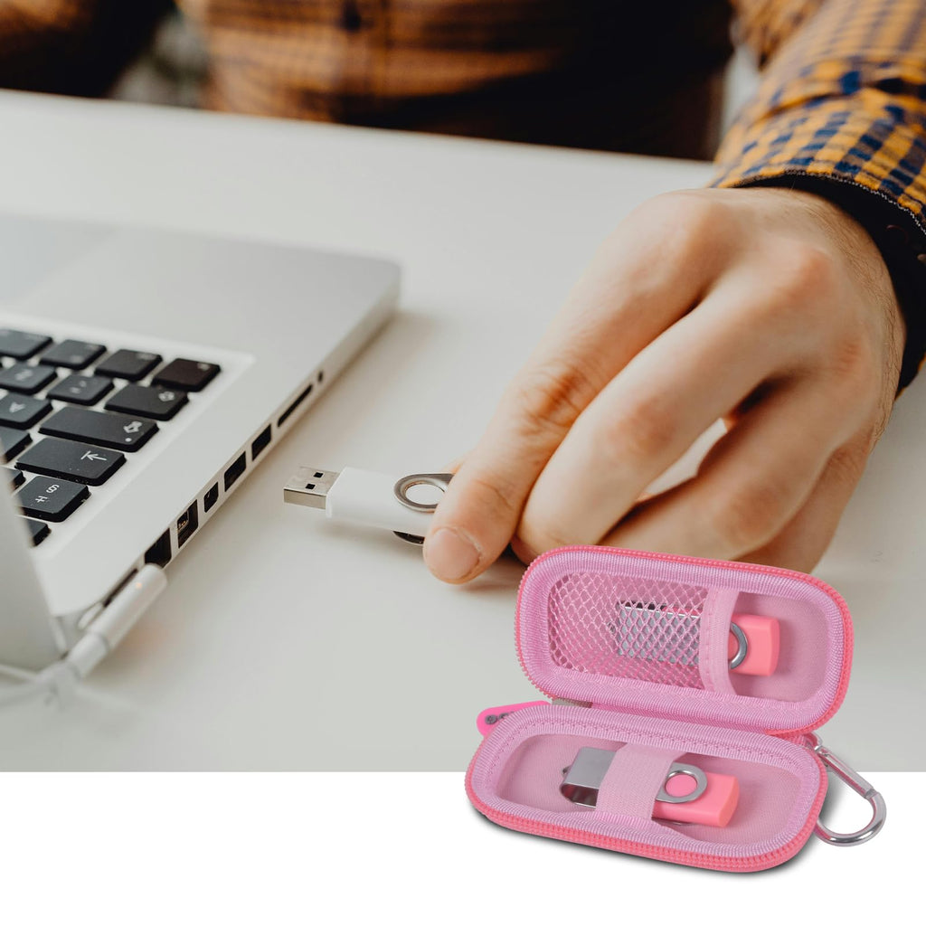 Light pink USB flash drive and SD card storage case open beside a laptop during use