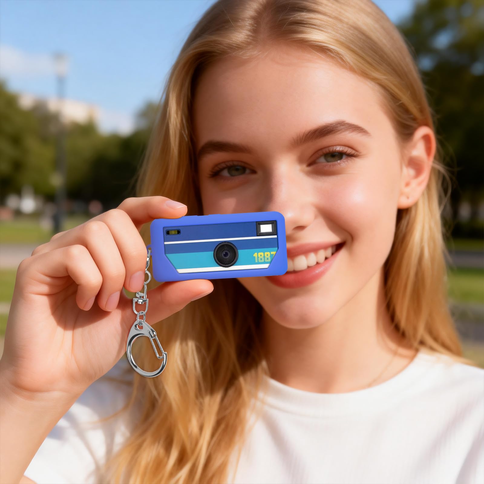 Blue with retro camera graphic silicone case for Kodak Charmera keychain camera shown with a woman holding the camera on its keychain