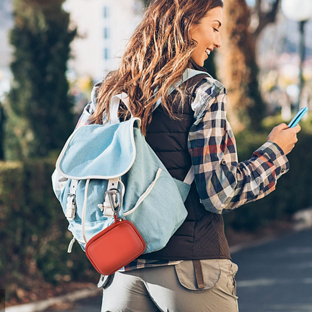 Red mini power bank case attached to a backpack for travel