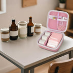 Open pink NIIMBOT label maker organizer beside bottles and jars