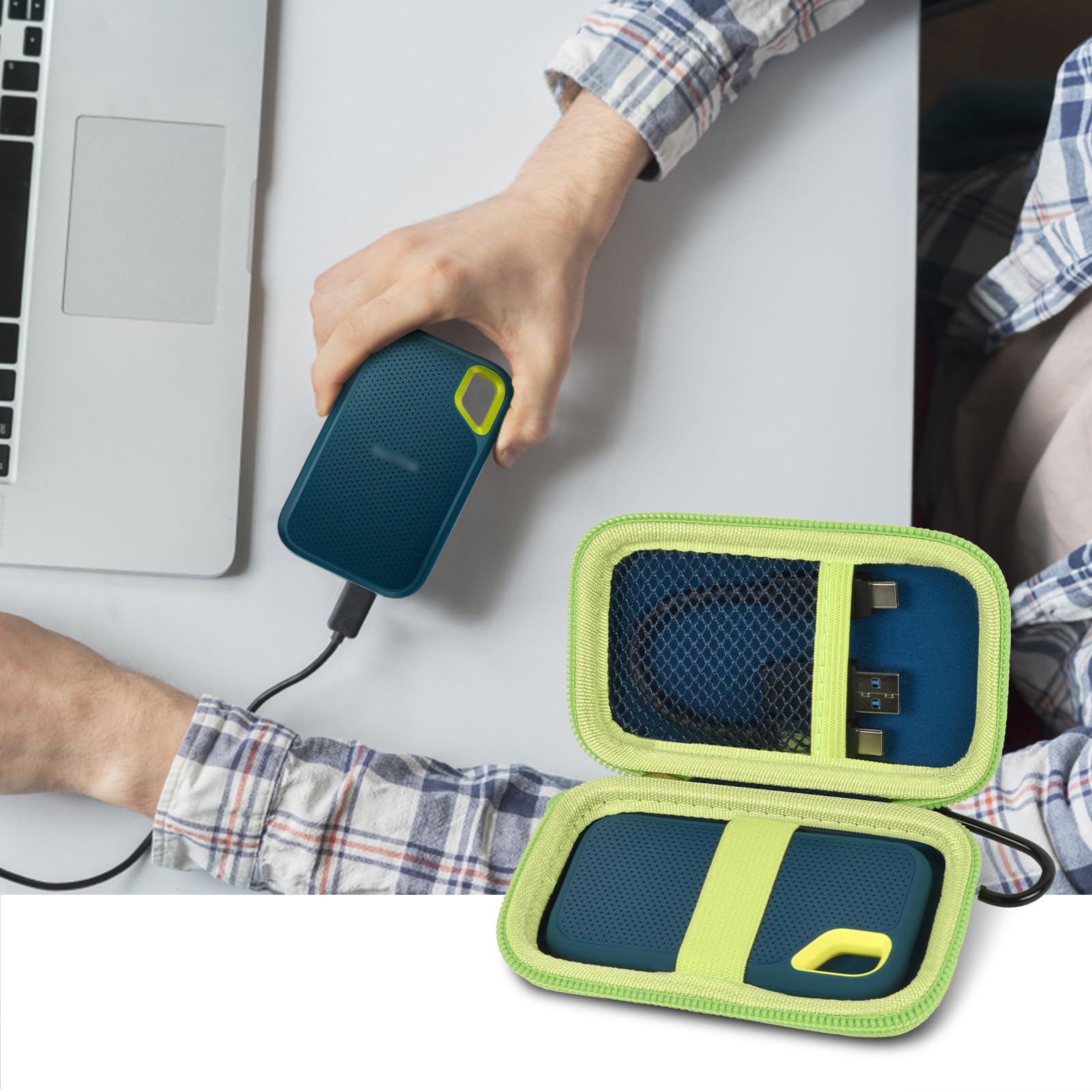 Open navy and green SSD organizer beside a SanDisk drive connected to a laptop