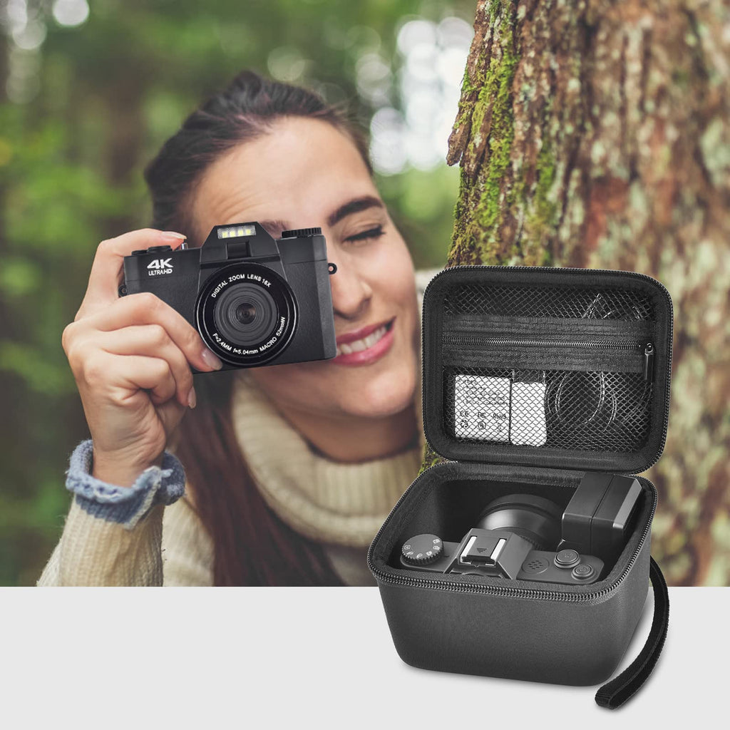 Photographer using a compact camera beside the open black organizer